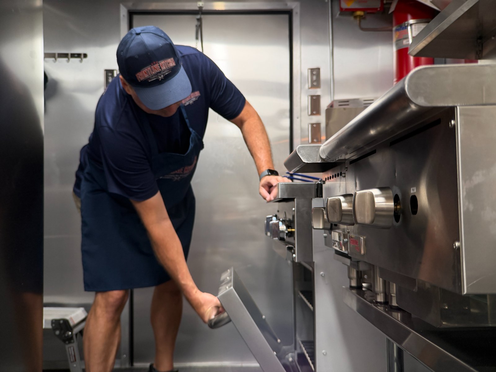 Working the range inside the Frontline Kitchen truck